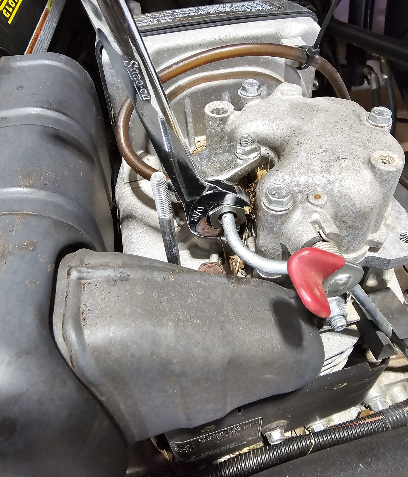 Wrench on an engine fitting during maintenance