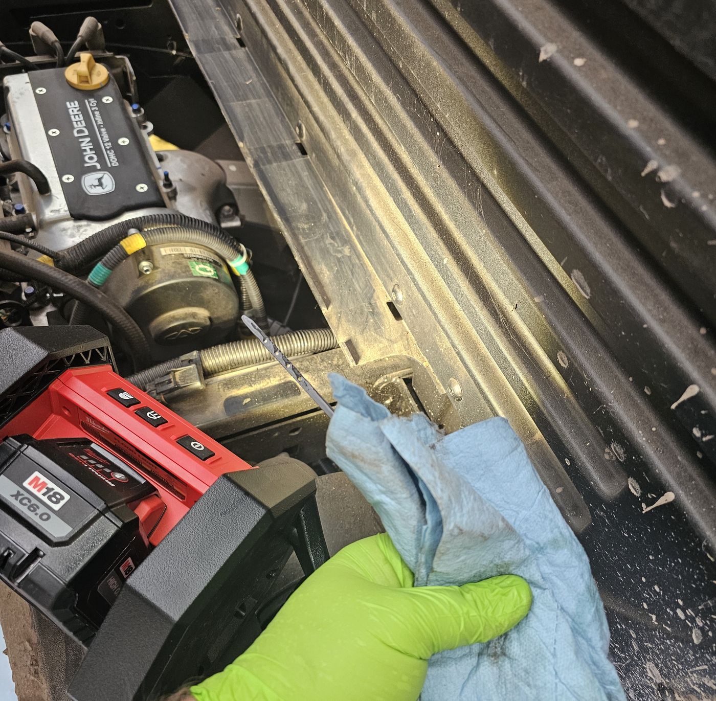 Checking the dipstick on a utility-vehicle engine